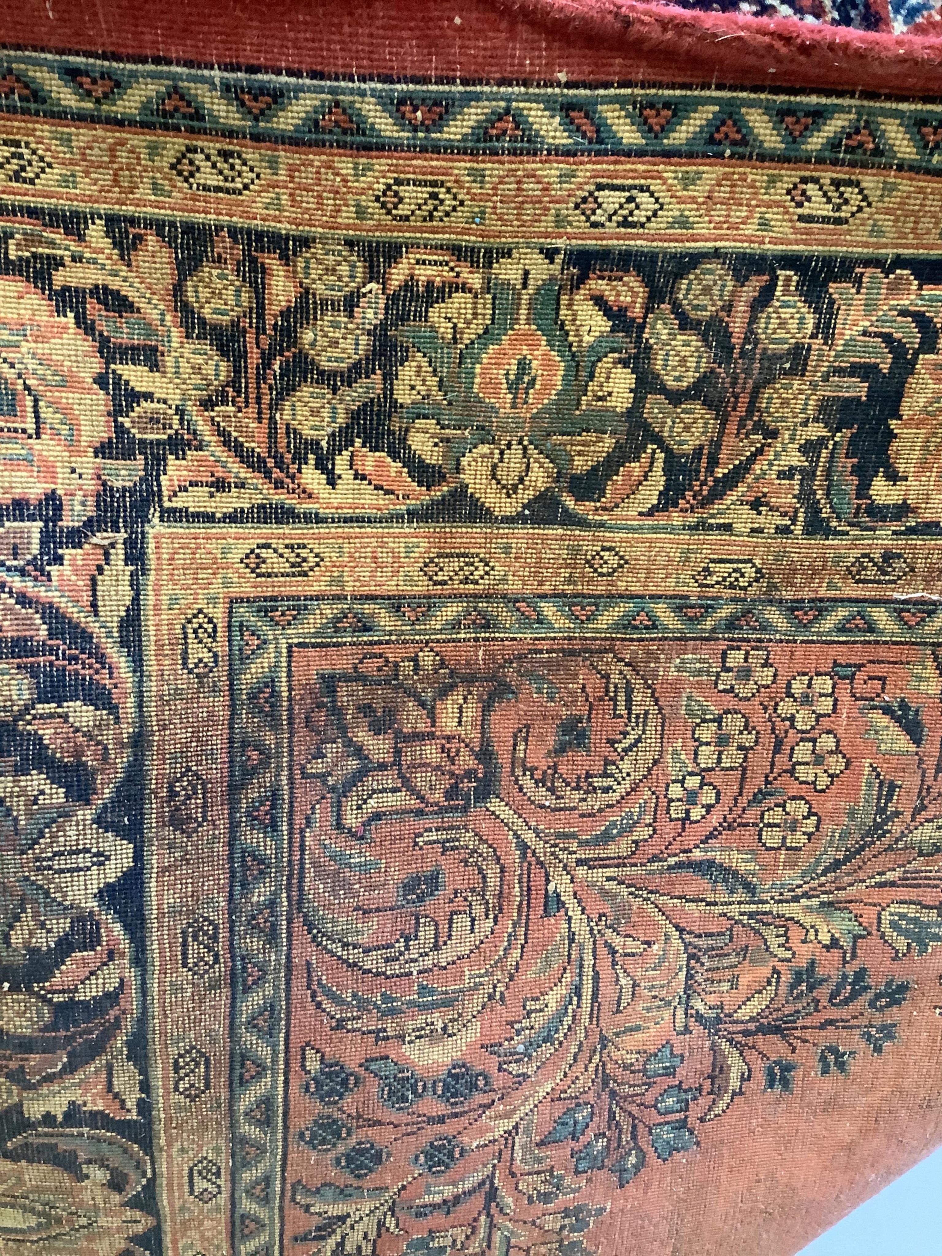 A Sarouk red ground rug, 244 x 151cm